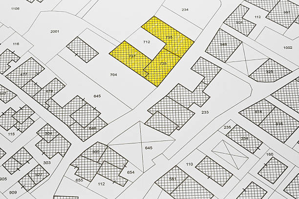 istock Imaginary cadastral map with buildings, land parcel and vacant plot - Land records and property registry with cadastre documentation and ownership parcel identification 2213540740
