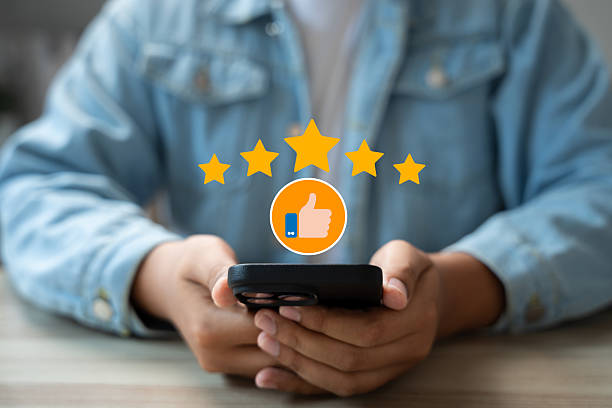 istock Customer using smartphone to provide five star product review with thumb up icon.Online feedback and satisfaction survey reflect service quality,Building trust,Improving digital brand reputation 2213541582