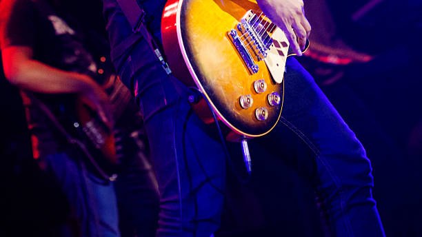 Young man plays electric guitar