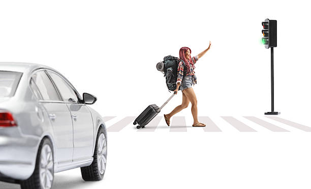 istock Female tourist walking and pulling a suitcase at a pedestrian 2213546971