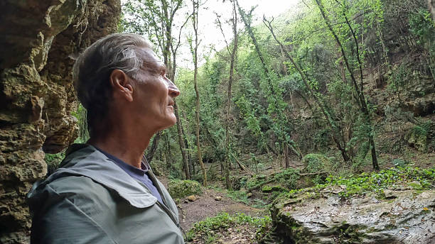 Profile of mature man in ancient ruins in forest, Liguria