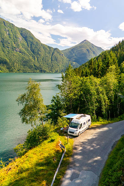 istock Explore the serene beauty of Norway with a camper van alongside tranquil waters 2213550256