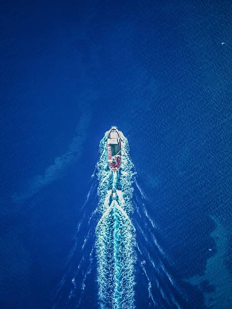 istock Aerial boat cruising in deep blue ocean. 2213556187