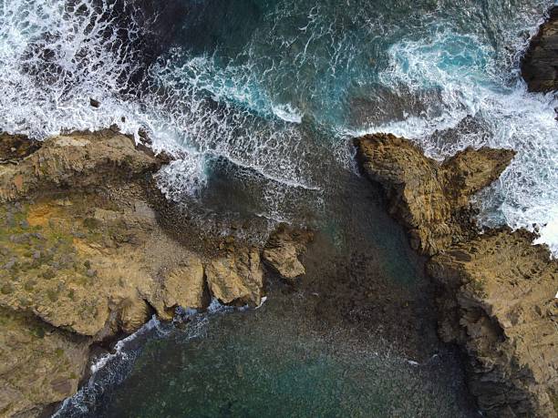 istock Aerial view of rugged coastline with waves and cliffs. 2213556195