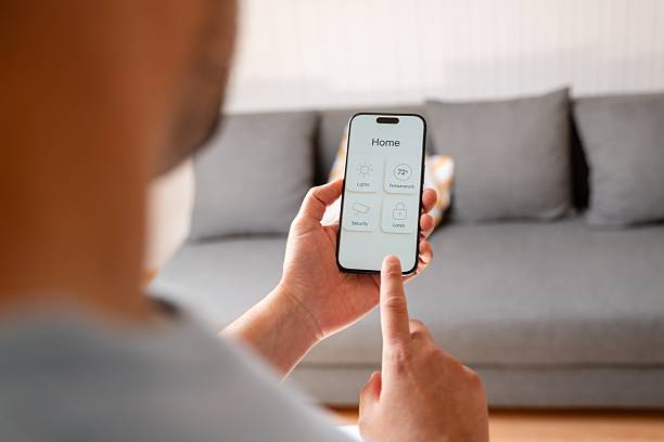 istock Man controlling home automation system with smartphone app 2213558083