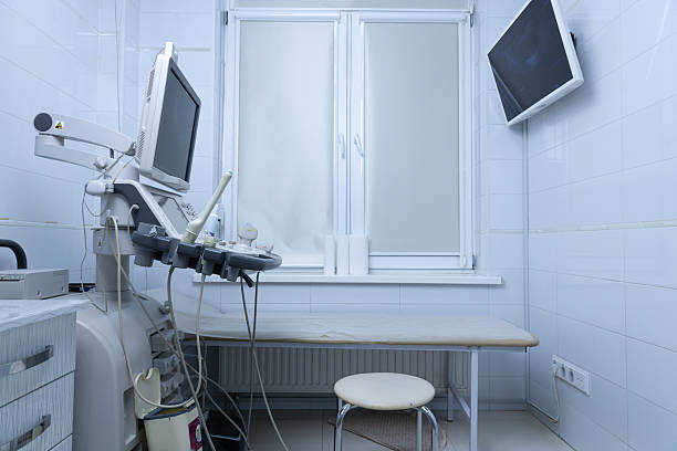 Inside a contemporary medical examination room equipped with state-of-the-art ultrasound machinery, a neat examination table, and minimalistic design ensuring a sterile clinical environment.