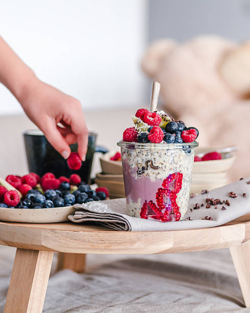 istock Chia pudding and smoothie parfait served on a small table with a plate of berries 2213559144