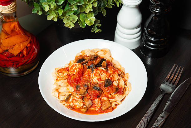 istock Tagliatelle pasta with shrimp and tomato sauce. 2213559400