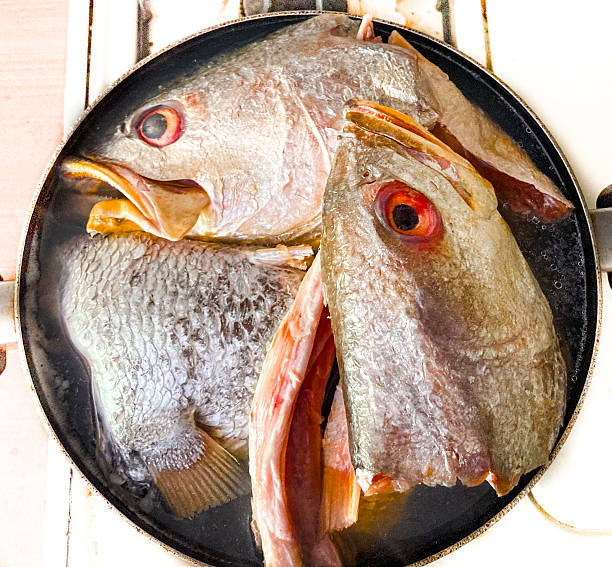 istock Raw heads of fish to be cooked 2213562649