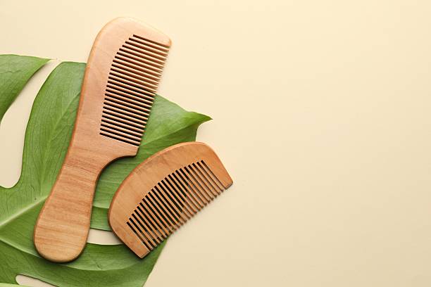 istock Wooden hair combs and monstera leaf on beige background, flat lay. Space for text 2213566548