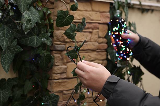 istock Man decorating house with Christmas lights outdoors, closeup 2213566881