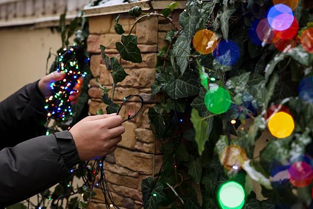 istock Man decorating house with Christmas lights outdoors, closeup 2213566898
