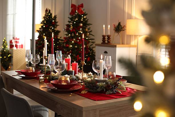 istock Christmas table setting with stylish dishware, glasses and burning candles in festive decorated room 2213567180