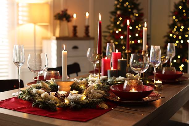 istock Christmas table setting with stylish dishware, glasses and burning candles in festive decorated room 2213567184