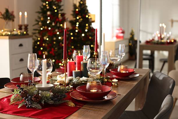 istock Christmas table setting with stylish dishware, glasses and burning candles in festive decorated room 2213567185