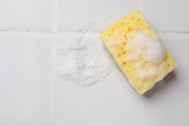 istock Sponge and foam on white tiled table, top view. Space for text 2213567233