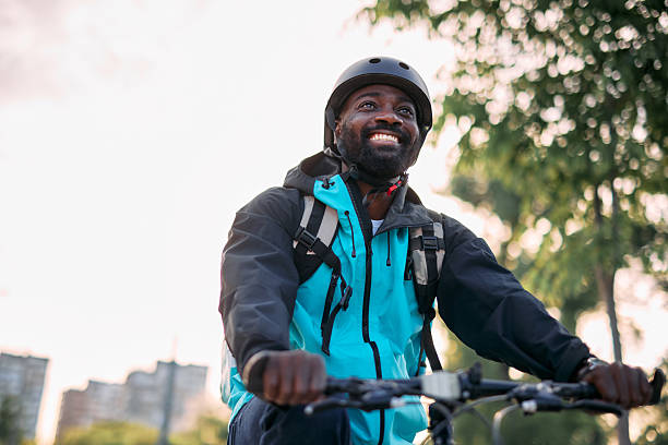 istock Young Adult Riding Bicycle with Joyful Expression 2213567502