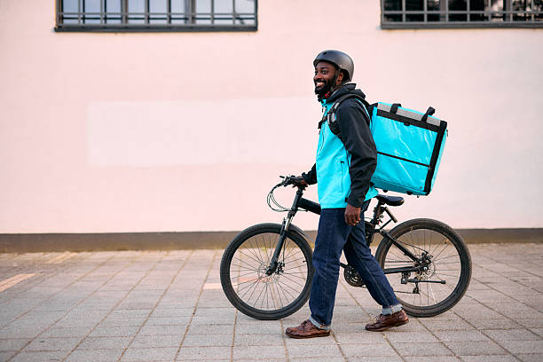 istock Young Adult Delivering Food on Bicycle 2213567775