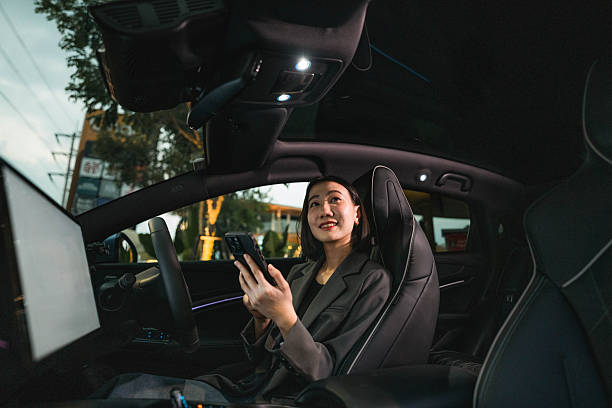 istock A woman exploring various features on the EV car's smart application through her smartphone 2213569400