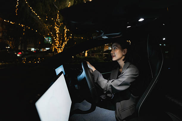 istock A woman using the EV car's app while driving home 2213569485