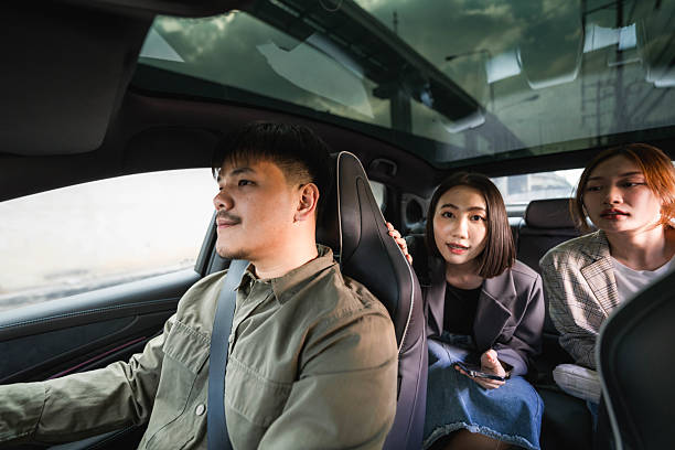 istock Smiling driver answering call from his customer as he pulls up to the pick-up point 2213569853