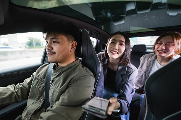 istock Smiling driver answering call from his customer as he pulls up to the pick-up point 2213569874