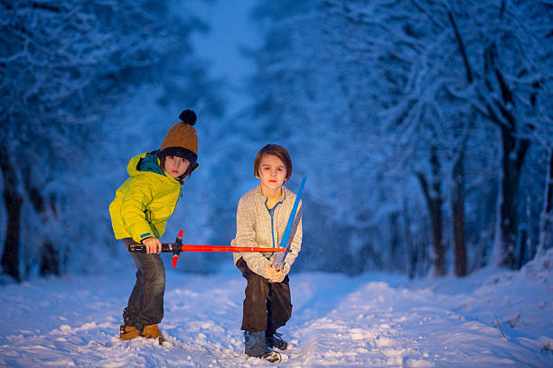 Little girl and boy enjoying sleigh ride. Child sledding. Brother and sister riding a sledge. Children play outdoors in snow. Kids sled in snowy park in winter. Outdoor fun for family vacation.