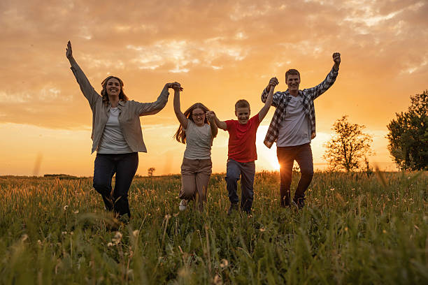 istock Family Fun at Sunset in the Open Field 2213574304