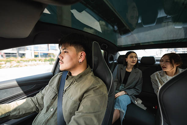 istock Two passengers talking in the backseat as the driver carefully navigates the road, making their way toward their destination 2213575381