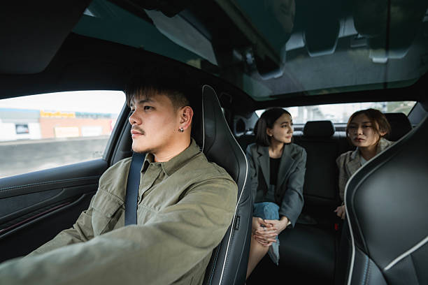 istock Two passengers talking in the backseat as the driver carefully navigates the road, making their way toward their destination 2213575407