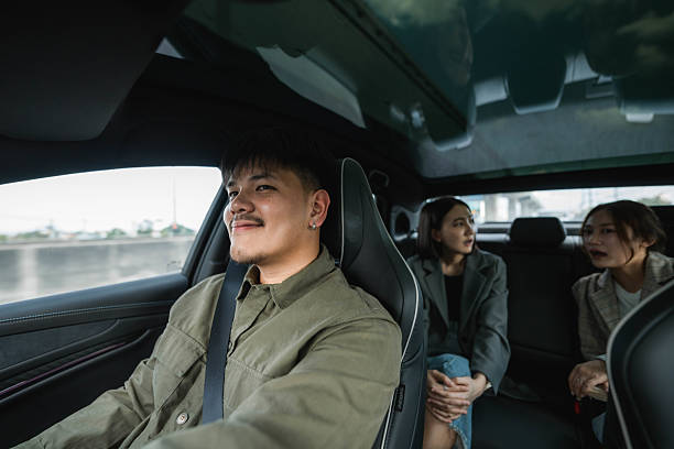 istock Two passengers talking in the backseat as the driver carefully navigates the road, making their way toward their destination 2213575426