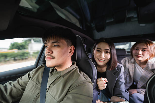 istock Smiling driver answering call from his customer as he pulls up to the pick-up point 2213575430