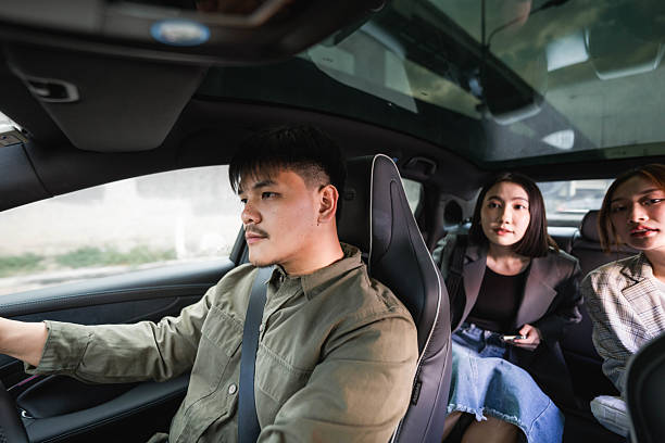 istock Smiling driver answering call from his customer as he pulls up to the pick-up point 2213575438