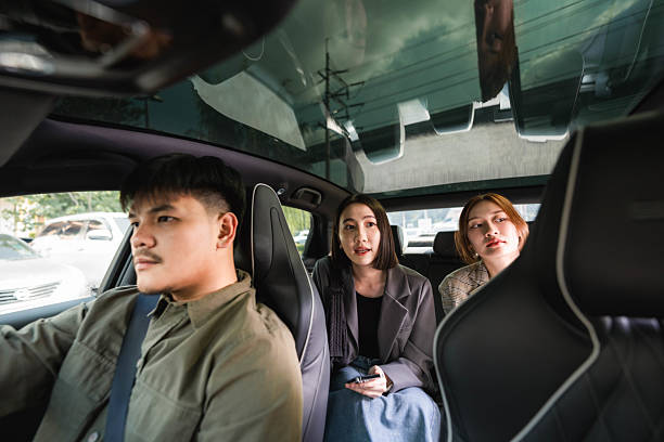 istock Smiling driver answering call from his customer as he pulls up to the pick-up point 2213575447