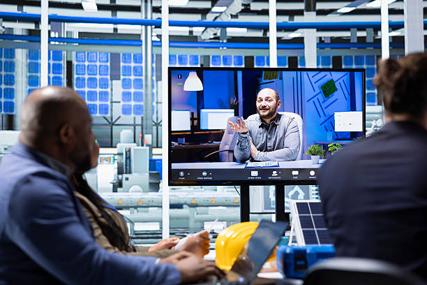 istock Investors evaluate solar panels plant production efficiency during videocall 2213576461