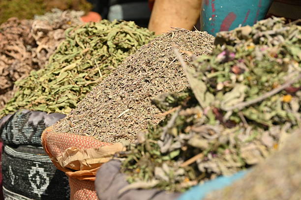 Different moroccan spices inside colorful fabric containers sold in a shop inside the medina in Marrakech, Morocco