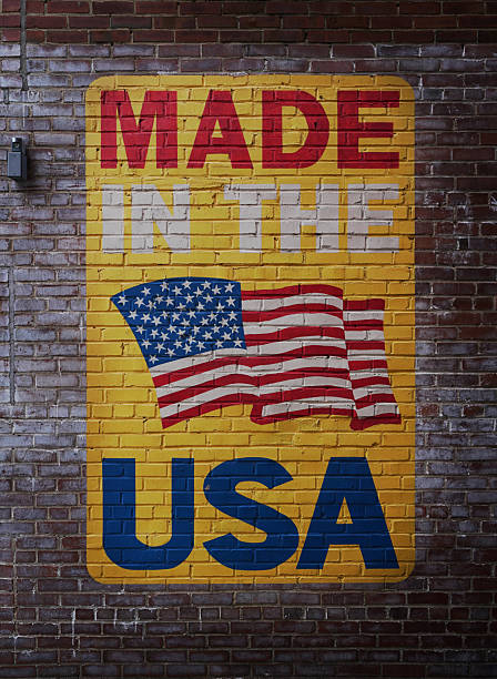 istock Made In The USA painted on brick wall with US flag 2213579508