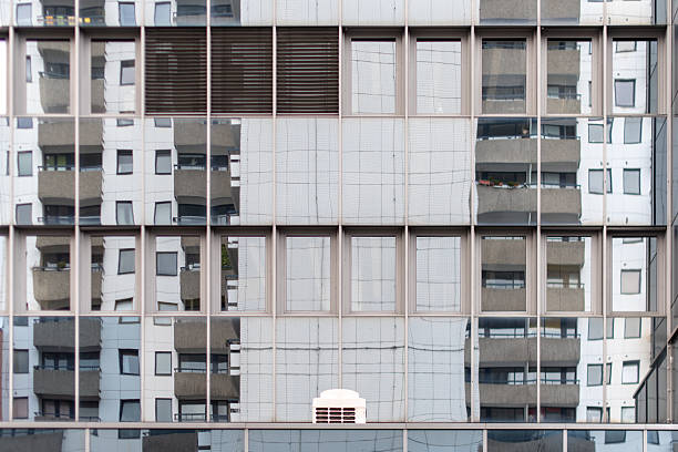 abstract minimalist partial view of a modern exterior facade with reflections in the windows