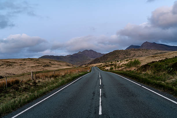 istock Serene Road Leading to Mountain Peaks at Dusk 2213581245