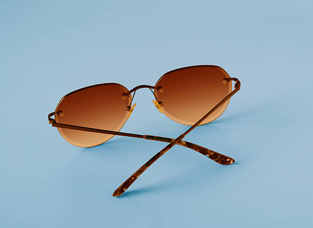 istock glasses with orange lenses on blue background, copy space 2213581423