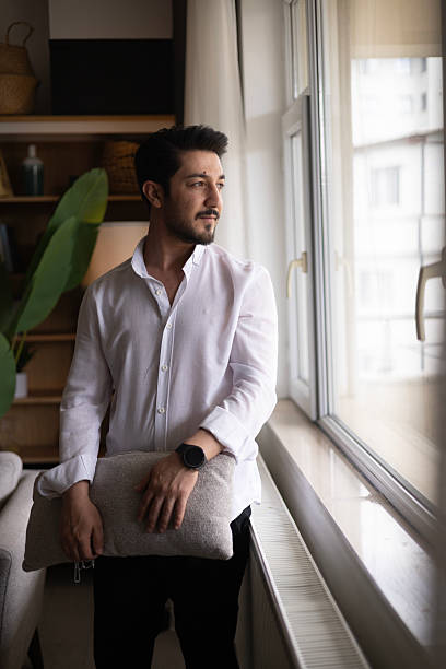 istock Young, handsome man in home interior 2213582245
