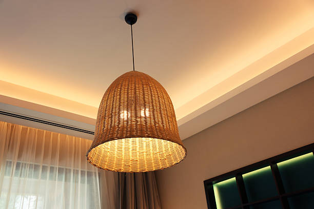 istock Stylish pendant lamp on ceiling indoors, low angle view 2213583208