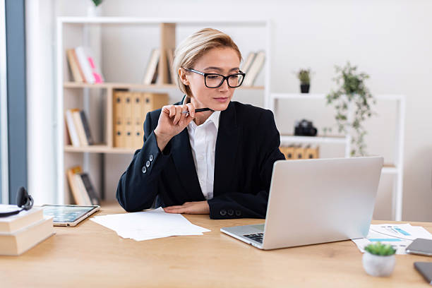 istock Confident businesswoman analyzing data at work desk in modern office environment 2213583843