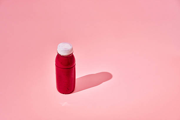 Red Berry Smoothie in Recycled PET Plastic Bottle on Vibrant Background
