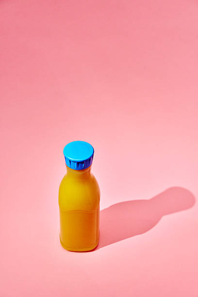 istock Orange Juice in Recycled PET Plastic Bottle on Vibrant Background 2213584214
