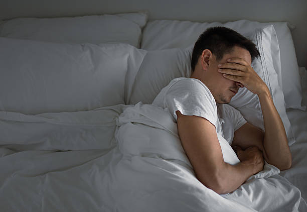 istock Emotional lonely man lying in bad can sleep feeling stressed. 2213584627