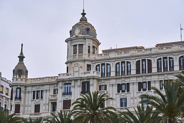 istock Elegant historic building with palm trees against a cloudy sky 2213587843