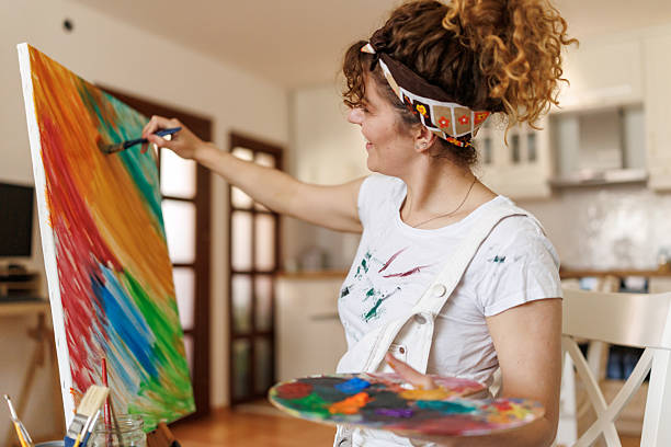 istock Beautiful female painter working at home 2213588477