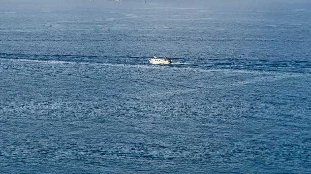 istock A Scenic View Featuring a Boat Gracefully Navigating the Calm and Serene Waters Around 2213590047