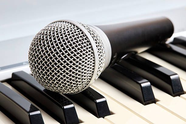 istock Microphone on midi piano keyboard keys. Recording studio concept. 2213590105